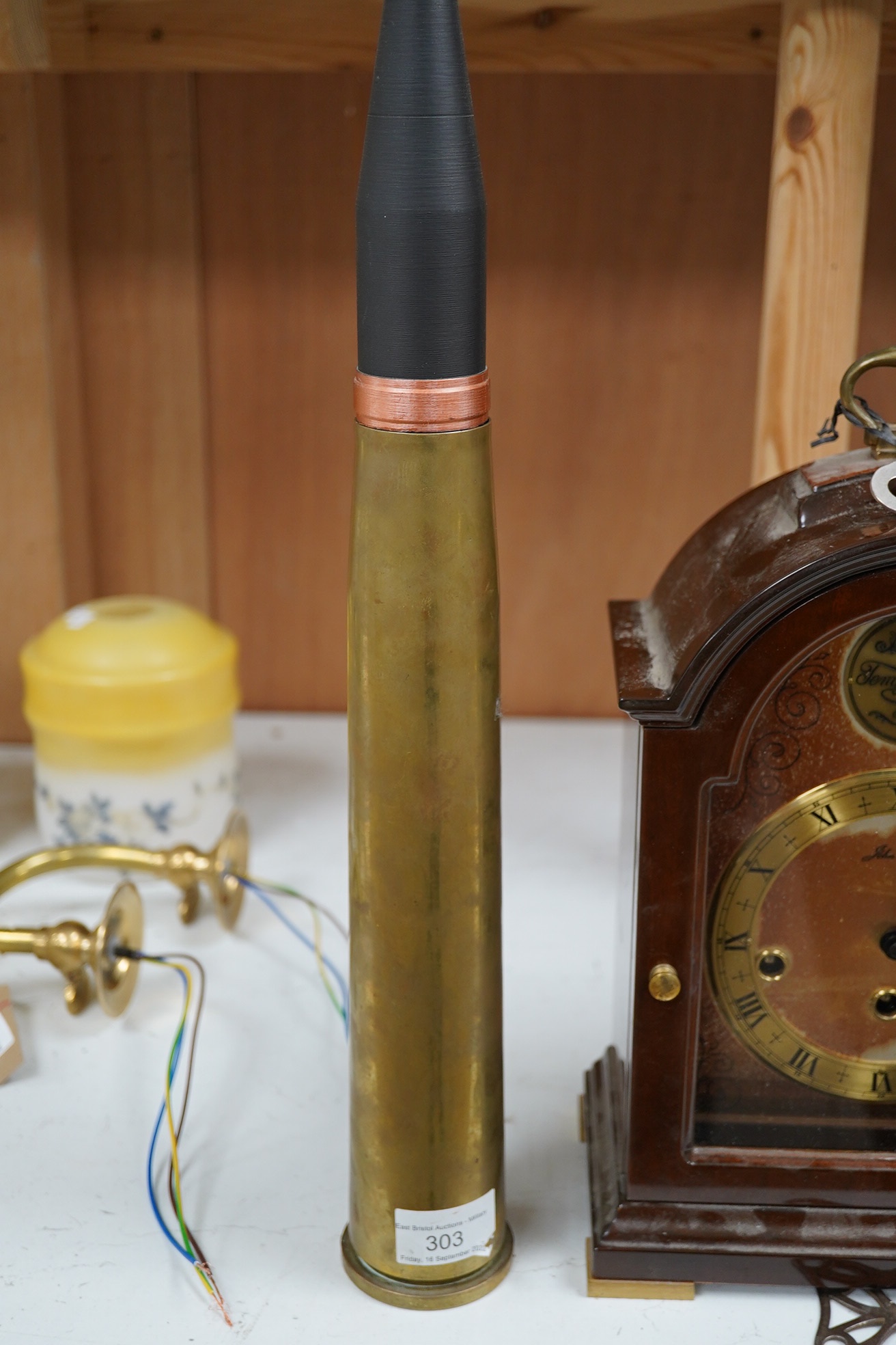 Two clocks including an American example, with keys and two military interest brass shells. Condition - fair